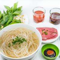 2. Large Steak Pho Noodle Soup · Vietnamese pho noodle soup served with steak rice noodle, garnished with green and white oni...