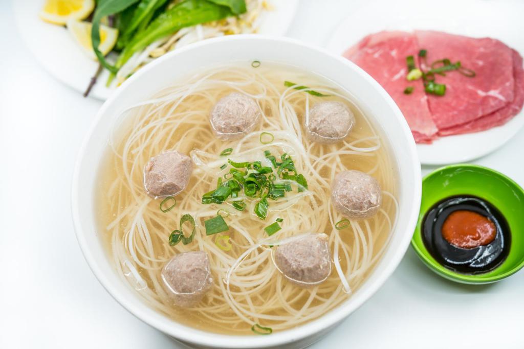 4. Large Steak and Beef Balls Pho Noodle Soup · Vietnamese pho noodle soup served with steak and beef ball, rice noodle, garnished with green and white onion.