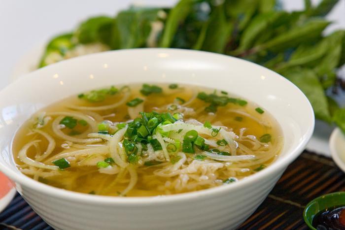 11. Large Plain Pho Noodle Soup · Vietnamese pho noodle soup served with rice noodle, garnished with green and white onion.