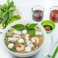 13. Large Seafood Pho Noodle Soup · Vietnamese pho noodle soup served with shrimp, fishcake, and squid, rice noodle, garnished w...
