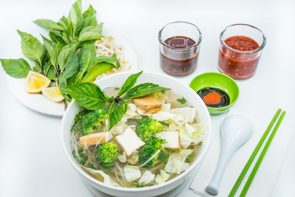 15. Large Vegetable Pho Noodle Soup · Vietnamese pho noodle soup served with broccoli, cabbage, fried tofu, garnished with green and white onion. Vegetarian.