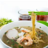 16. Large Ha Long Egg Noodle Soup · Slow cooked pork, squid and shrimp garnished with chives, green onion, fried scallions and e...