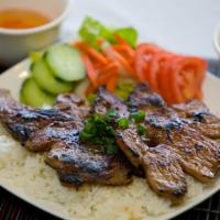 BBQ Pork Chop Rice Plate · Rice plates (com phan) includes steamed white jasmine or brown rice and tossed salad.