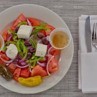 Hortiatiki Village Salad · Tomatoes, cucumbers, feta cheese red onions, bell peppers and olives. Dressed with olive oil...