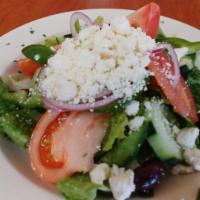 Greek Salad · Iceberg lettuce topped with tomatoes, red onions, cucumbers, Kalamata olives, green peppers ...