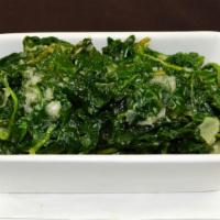 Espinaca Salteada · Sautéed spinach, shallots, butter and extra virgin olive oil.