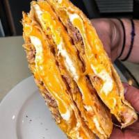 Sunrise Quesadilla · Grilled sliced beef with scrambled egg and mozzarella cheese quesadilla style with a side of...