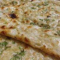 Garlic Naan · Pressed with chopped fresh garlic. Baked to perfection in charcoal powered tandoor oven.