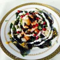 Palak Chaat · Fresh baby spinach flash fried and drizzled with tangy yogurt.