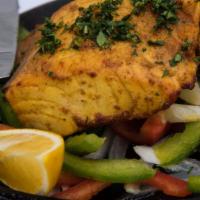 Masala Salmon · Hearty fillets of salmon seared with yogurt, turmeric and spices.