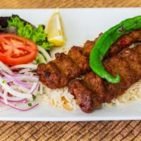 Dinner Lamb Adana Kebab · Skewered ground lamb flavored with red bell peppers. Served with rice, grilled pepper and to...