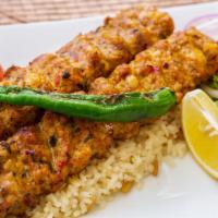 Dinner Chicken Adana Kebab · Skewered ground chicken flavored with red bell peppers. Served with rice, grilled pepper and...