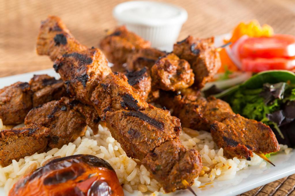 Dinner Lamb Cop Shish Kebab · Small cubes of marinated lamb on skewer. The marination of the lamb cop shish contains dairy. Served with rice, grilled pepper and tomato, and side of fresh house salad.
