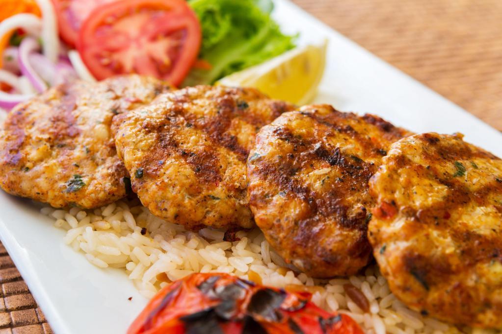 Dinner Chicken Kofte Kebab · Ground chicken blended with eggs, onions, garlic, parsley and spices. Served with rice, grilled pepper and tomato, and side of fresh house salad.