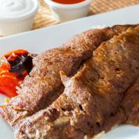 Dinner Lamb Gyro (Doner) · Thinly sliced lamb seasoned with herbs and spices. The marination of gyro contains dairy. Se...