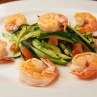 Gamberi Grigliati · Grilled shrimp over sauteed zucchini, pine nuts and plum tomato.