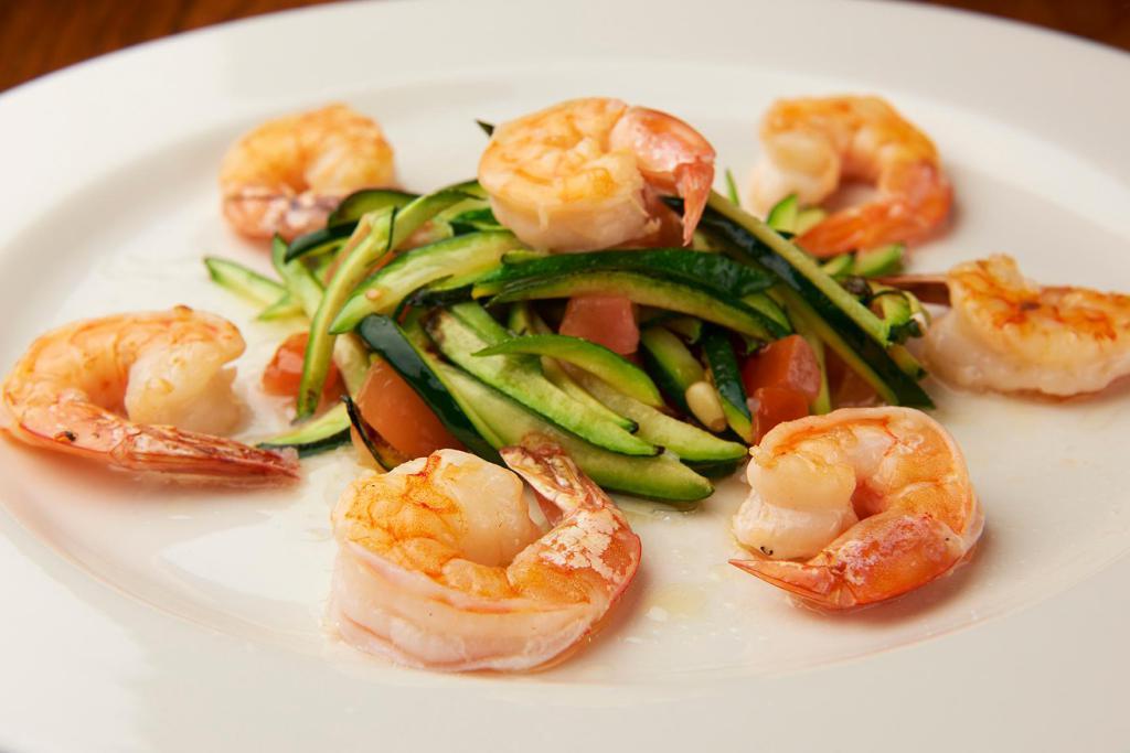 Gamberi Grigliati · Grilled shrimp over sauteed zucchini, pine nuts and plum tomato.