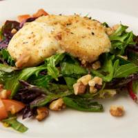 Insalta Caprini · Goat cheese baked over field greens salad with walnuts.
