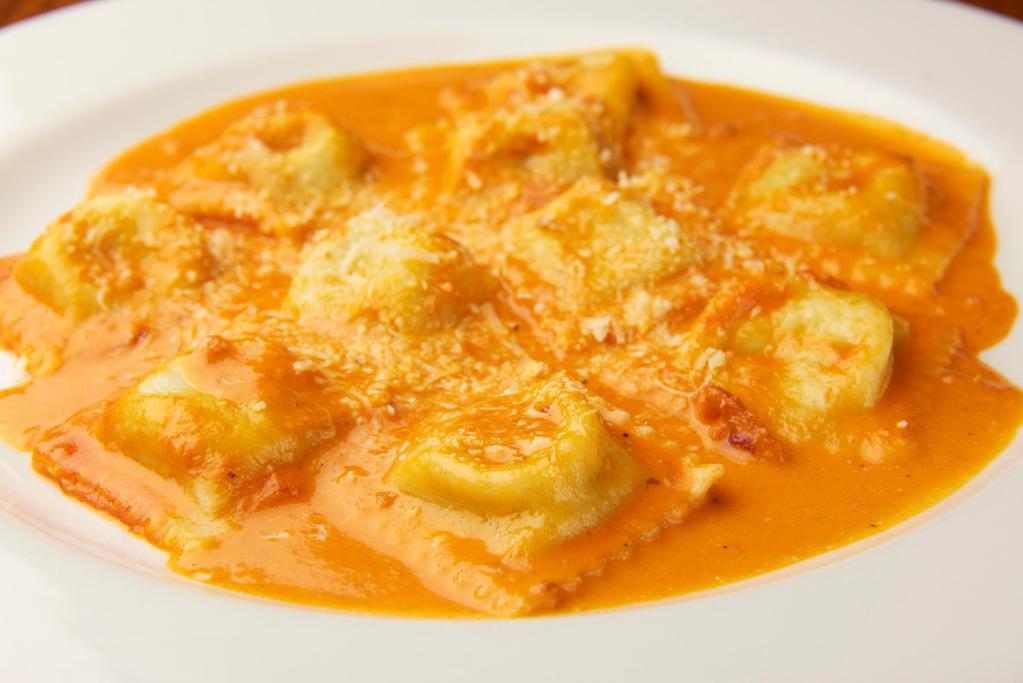 Ravioli Piamontese · Filled with spinach and cheese in a pink sauce.
