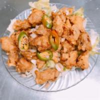 C21. Salt and Pepper Chicken · Chicken dark meat battered, fried then sauteed with caramelized onions and jalapeno in our s...