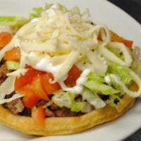 Sopes · Sope is a thick corn tortilla topped with refried beans, meat, lettuce, cheese and crema.