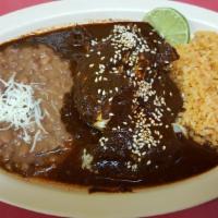 Oaxacan Mole plate · Braised chicken, traditional chocolate, chile sauce, rice beans and sesame seeds.
