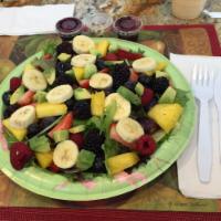 Fruit Salad · Delicious seasonal fresh fruit with avocados over spring mix. Walnuts and house Raspberry Vi...
