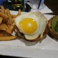 Green Eggs and Spam Burger · Our burger topped with pan seared spam, over easy egg, pepper jack, pesto. Served with fries...