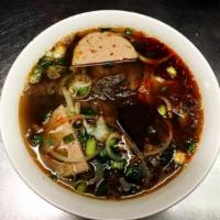 E10. Bún Bò Huế · Vietnamese rice noodle spicy soup with beef. Spicy.