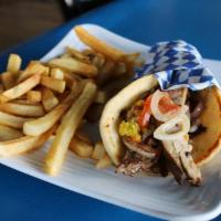 Pork Souvlaki Sandwich · Grilled pork wrapped in a pita with tomatoes, red onions, lettuce and tzatziki.