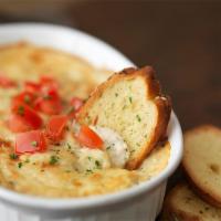 Shrimp and Crab Dip · A creamy shrimp, crab, and Parmesan dip baked and topped with diced fresh tomatoes. Served w...