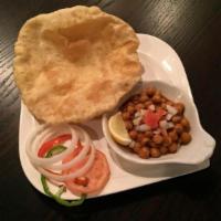 25. Poori Chole · Pooris (puffed bread) served with chickpea curry. Vegetarian.