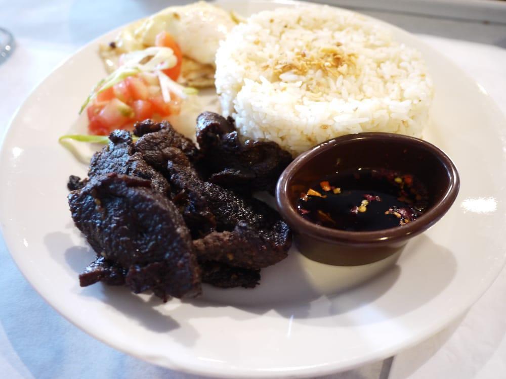 Tapsilog · Marinated cured beef. Served with coffee and garlic fried rice. Coffee will not be included for take out orders unless specified in special instructions to include the coffee.