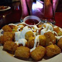Loaded Tater Tots · Queso, sour cream, scallions and bacon.
