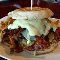 Breakfast Burger · Bacon, swiss cheese, fried egg, smashed tots, and hollandaise sauce. Served with a side.