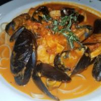 Seafood Trio · Sauteed Shrimp, calamari, and mussels served over Linguini with your choice of white wine or...