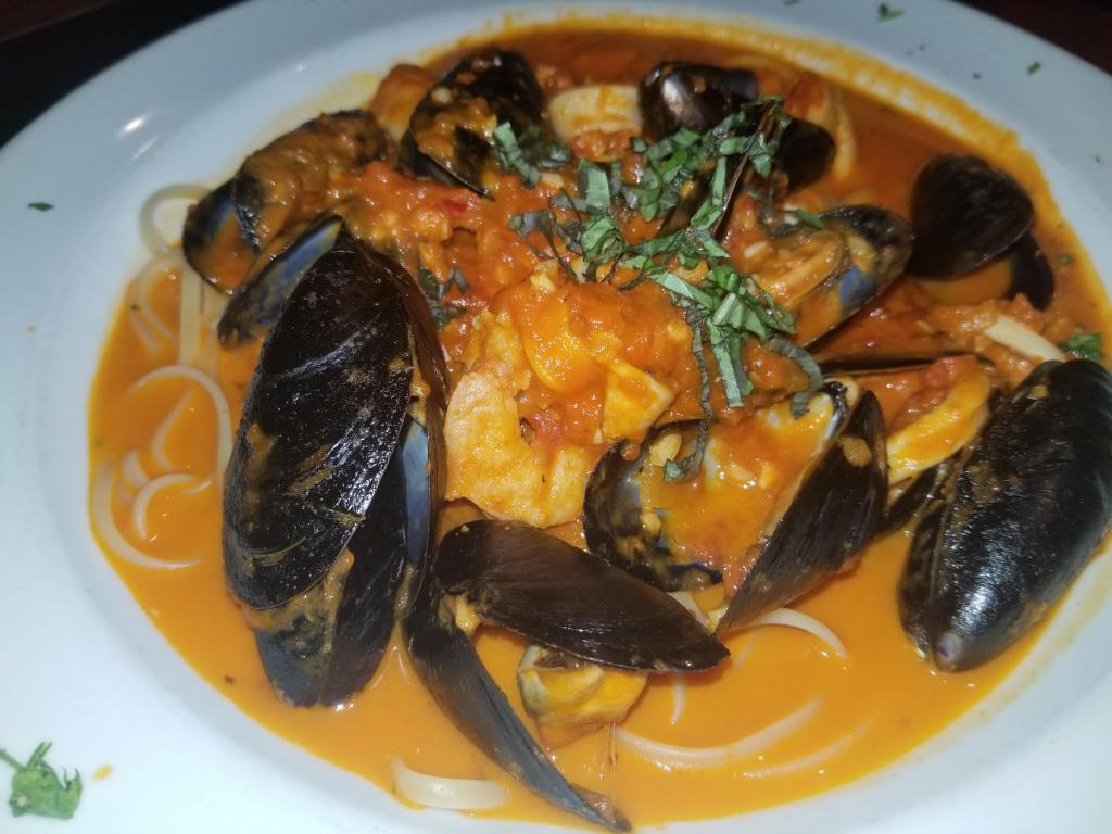 Seafood Trio · Sauteed Shrimp, calamari, and mussels served over Linguini with your choice of white wine or spicy marinara sauce.
