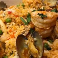 Arroz con Mariscos · Paella. Shrimp, squid, mussels, octopus, jasmin, rice, aji panca, and cilantro.