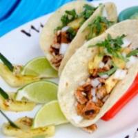 Tacos al Pastor · Marinated pork loin in a special adobo sauce with grilled pineapple wrapped in 3 soft corn t...
