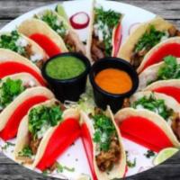 Autentico Tacos  · Mexican tacos. Three warm soft corn tortillas filled with your choice of meat, topped with c...