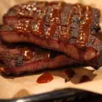 3 Bone Spare Rib Sandwich · Hickory smoked St. Louis style pork spare ribs on a bed of sliced bread with house BBQ sauce.