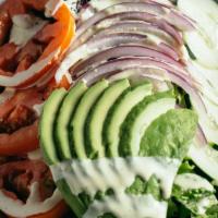 Ensalada del Huerto · Spring mix, onion, tomato, cucumber, avocado, House vinaigrette.