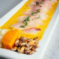 Tiradito de Aji Amarillo · Thinly cut fresh fish slices bathed in our leche de tigre and a touch of Peruvian yellow pep...