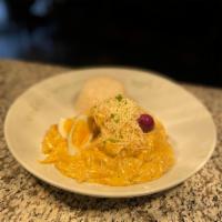 Aji de Gallina · Shredded chicken breast covered in Peruvian yellow pepper cream, boiled egg, Botija olive, P...