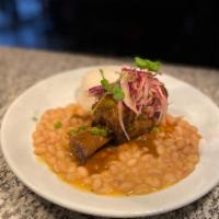 Seco de Res · Slow cooked cilantro braised beef short rib, canary bean, and rice, seco sauce and salsa cri...