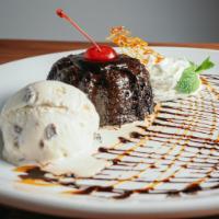Volcan · Chocolate lava cake topped with rum raisin ice cream.