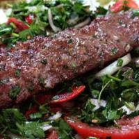 Kafta Wrap · A delicious wrap with fresh tomatoes, onion, parsley and pickle flavored with tahine and gar...