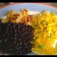Huevos Rancheros · Crispy corn tortillas topped with black beans, sauteed peppers and onions, fried eggs, shred...