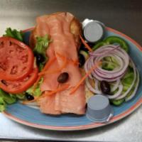 The Great toasted Bagel Deluxe · Nova Scotia lox, cream cheese, lettuce, Bermuda onion, tomato, olives and garnish. 