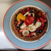 Belgian Tropical Waffle · Topped with fresh strawberries, bananas, peach halves, whipped cream and raisins.